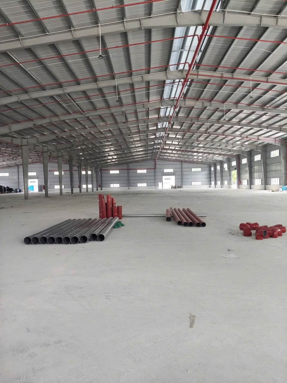 Không gian bên trong xưởng Mỹ Phước 3 với hệ khung mái và đường ống màu đỏ